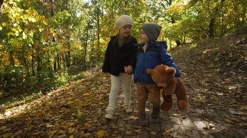 Cute smiling siblings walking hand in hand outdoor Video stock 117939254