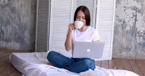 Cute smiling woman using digital tablet at home. Student girl reading or Stock Footage 130797789