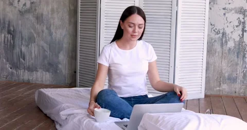 Cute smiling woman using digital tablet at home. Student girl reading or Stock Footage 130797923