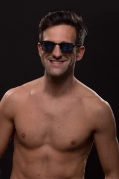 Cute smiling young man posing sunglasses body shirtless Stock Photos