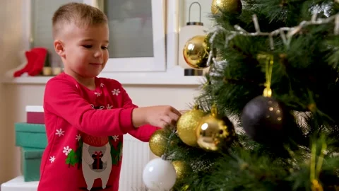 Cute son decorating the christmas tree with his father in the living room Stock Footage 165290874