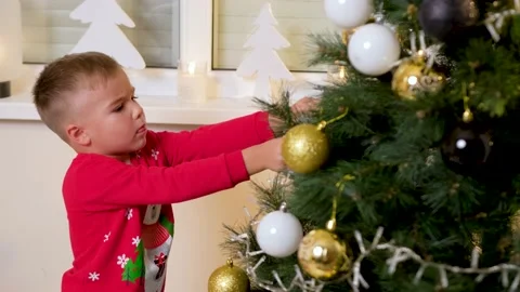 Cute son decorating the christmas tree with his father in the living room Stock Footage 222578603