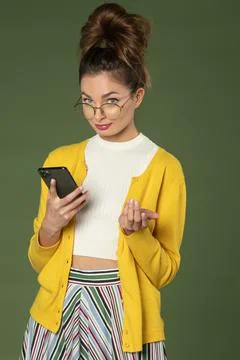 Cute student looking in camera with mobile Stock Photos
