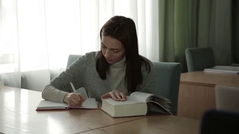 Cute student writes in the exercise book Stock Footage 73365251