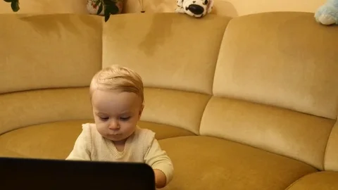 Cute surprising toddler pressing button on laptop - camera motion around Stock Footage 83923777