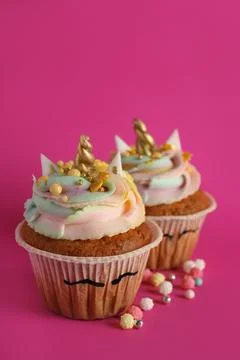 Cute sweet unicorn cupcakes on pink background Stock Photos