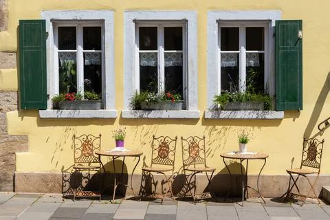 Cute table &amp; chairs by shuttered windows Stock Photos