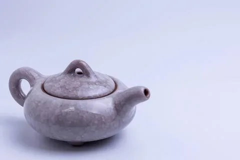 Cute teapot with frog face design on a light background Stock Photos