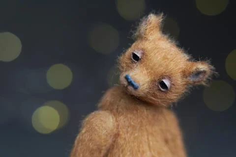 Cute teddy bear isolated on light background. Holiday glowing backdrop. Def.. Stock Photos