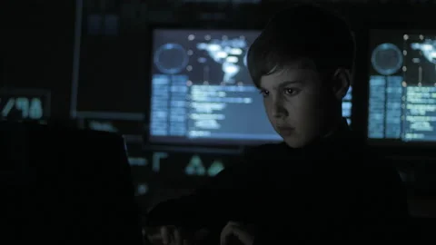 Cute teen boy programmer working at a computer in the data center filled with Stock-Footage 86444514