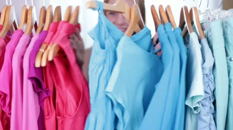 Cute Teen/Tween Pops up through Clothes Rack and Gives Thumbs Up Stock Footage 12540376
