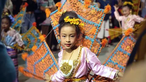 Cute Thai child performing King Ka-La bird dance with fan wings smiling at 動画素材 335174658
