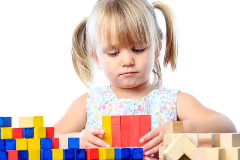 Cute three year old playing with wood blocks. Stock Photos