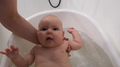 Cute toddler bathing in small plastic tub Stock Footage 228798529