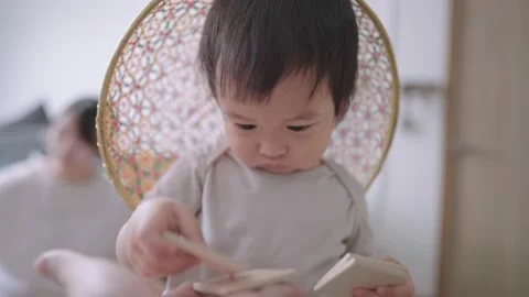 Cute toddler being asked and gives some toys to father, generosity in childhood Stock Footage