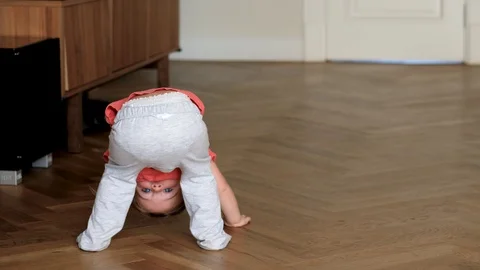 Cute toddler doing tricks at home Stock Footage 128626511