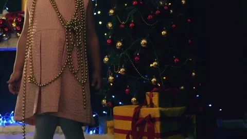 Cute toddler girl posing on background of decorated Christmas tree Stock Footage 70197665
