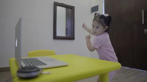 Cute toddler learning to dance through online class Stock Footage 158990209
