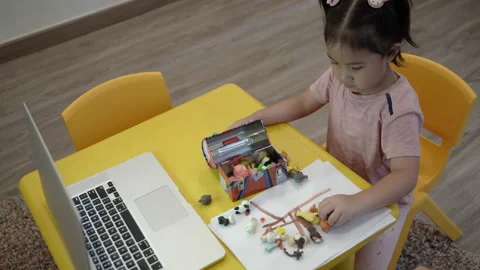 Cute toddler learning to tidy up Stock Footage 158975753