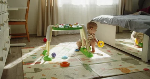 Cute toddler looking at his reflection in the mirror while playing Stock Footage 304658845