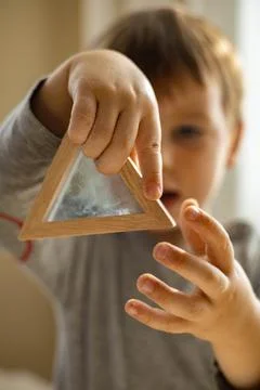 Cute toddler playing self development home kinetic sandbox use Maria Montessori Stock Photos