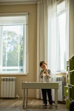 Cute toddler playing self development home kinetic sandbox use Maria Montessori Stock Photos