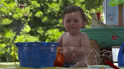 Cute toddler plays in backyard Stock Footage 148792303