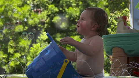 Cute toddler plays in backyard Stock Footage 148792903