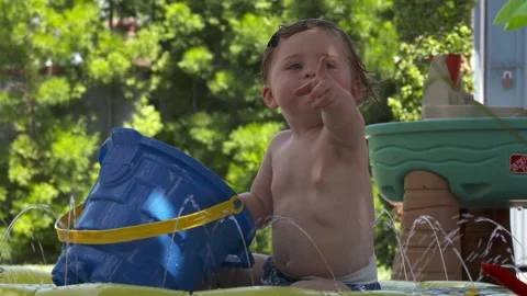 Cute toddler plays in backyard Stock Footage 148792935