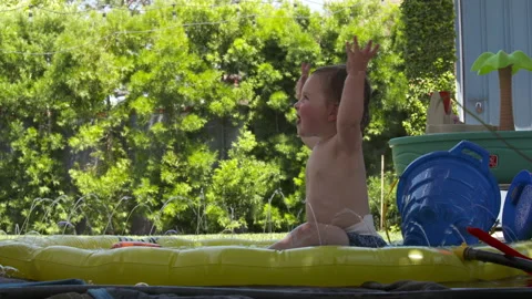 Cute toddler plays in backyard Stock Footage 148793301
