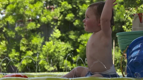 Cute toddler plays in backyard Stock Footage 148793507