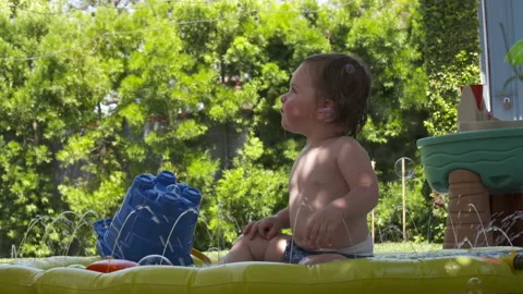 Cute toddler plays in backyard Stock Footage 148793796