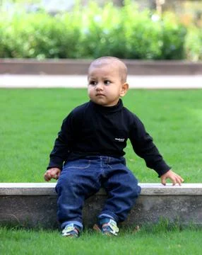 A cute toddler is posing with a style Stock Photos