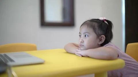 Cute toddler sitting down nicely and paying attention on online class Stock Footage 158966274