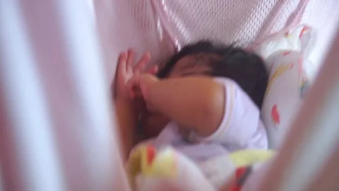 Cute toddler sleeping peacefully and soundly in a cradle. Stock Footage 107849030