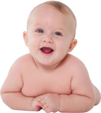 Cute toddler smiling while lying on his tummy Stock Photos