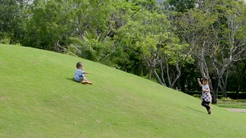 Cute toddler walk down the hill and sit down Stock Footage 150786517