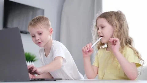 Cute two children primary school age girl and boy studying together at home Stock Footage 276629541