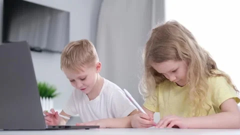 Cute two children primary school age girl and boy studying together at home Stock-Footage 276629551
