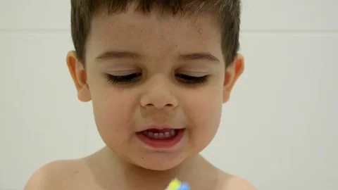 cute two years old boy brushing his Stock Video Pond5