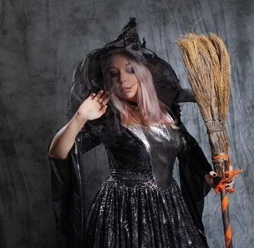 Cute witch with a broom, preparing to fly to the sabbath. Stock-Fotos