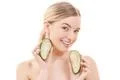 The cute woman with an avocado on the white background Photo
