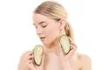 The cute woman with an avocado on the white background Photo