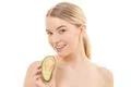 The cute woman with an avocado on the white background Photo