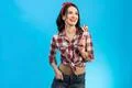 The cute woman with the candy standing on the blue background Photo