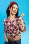 The cute woman with a candy standing on the blue background Photo