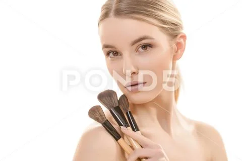 The cute woman with cosmetic brushes on the white background Stock Photos