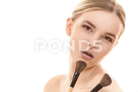The cute woman with cosmetic brushes on the white background Stock Photos