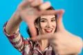 The cute woman gesturing on the blue background Photo