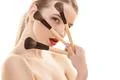 The cute woman holding cosmetic brushes on the white background Photo
